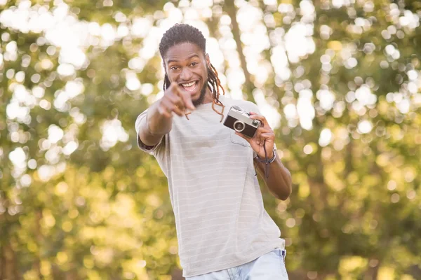 Handsome hipster using vintage camera — Stock Photo, Image