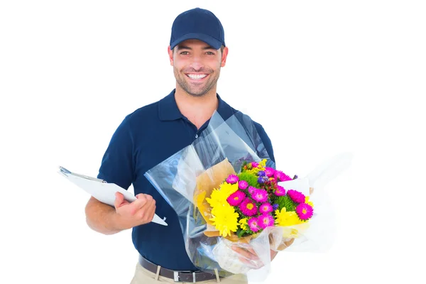 Homem entrega flor segurando prancheta — Fotografia de Stock