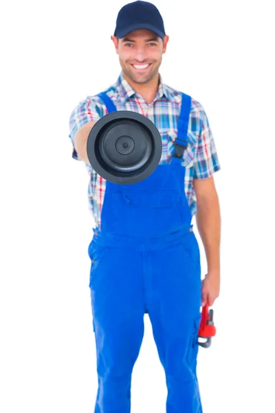 Handyman holding plunger and wrench — Stock Photo, Image