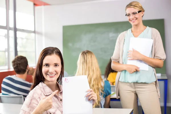 Vacker kvinnlig student pekar på papper — Stockfoto