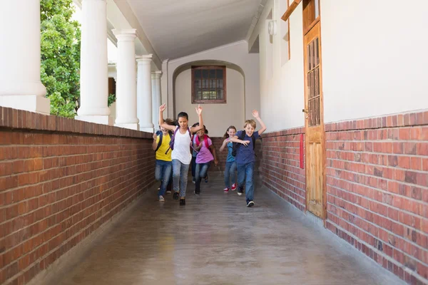 Cute pupils running down the hall — Stock Photo, Image