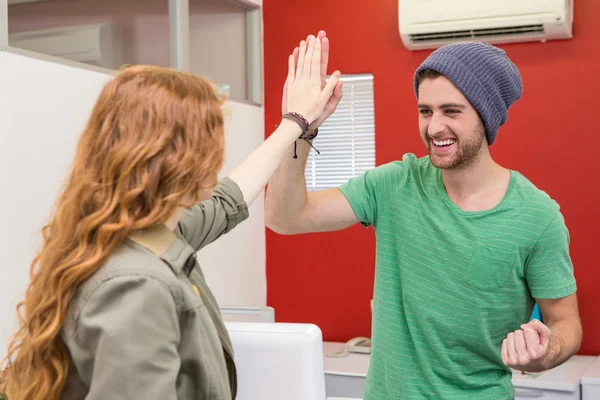 Casual businessman and woman high fiving — Stock Photo, Image