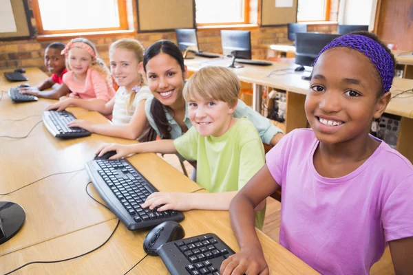 Cute pupils in computer class with teacher — Stock Photo, Image