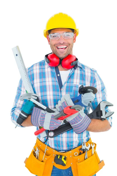 Manual worker holding various tools Stock Image