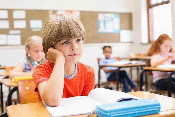 Concentrate pupils sitting at his desk Stock Image