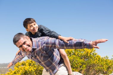 Father and son hiking through mountains  clipart