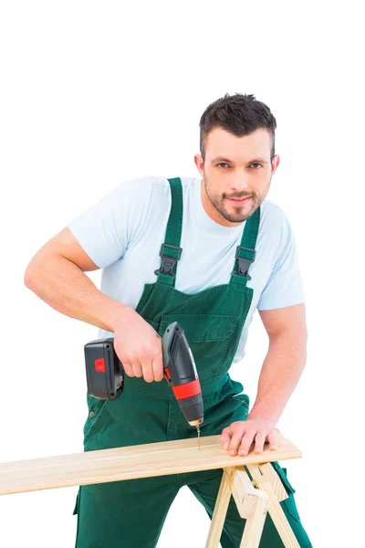 Carpenter drilling hole in plank — Stock Photo, Image