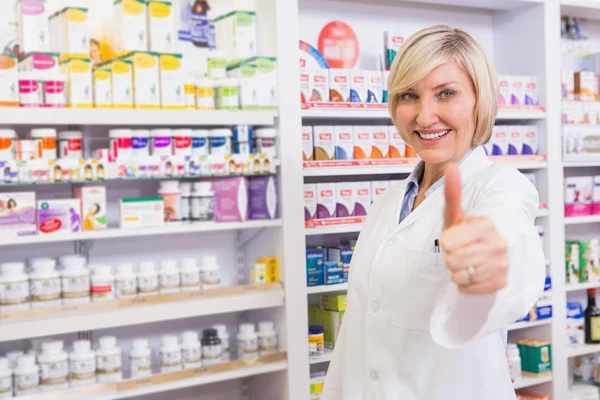 Positive blonde pharmacist with thumb up — Stock Photo, Image