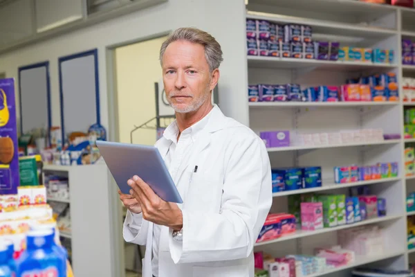 Senior pharmacist using tablet pc — Stock Photo, Image