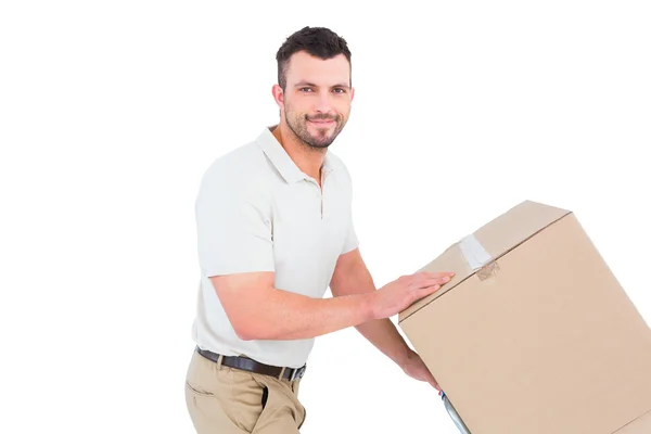 Delivery man pushing trolley of boxes — Stock Photo, Image