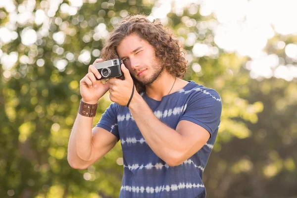 Handsome hipster using vintage camera — Stock Photo, Image