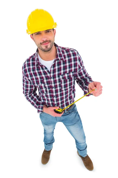 Smiling handyman holding tape measure — Stock Photo, Image