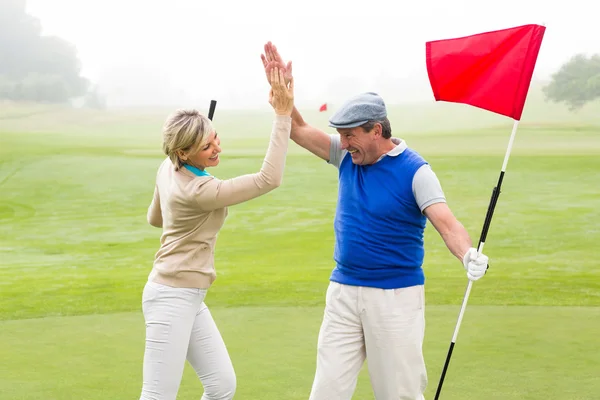 Paar beim High-Fiving auf Golfplatz — Stockfoto