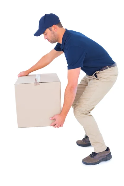 Courier man picking up cardboard box — Stock Photo, Image