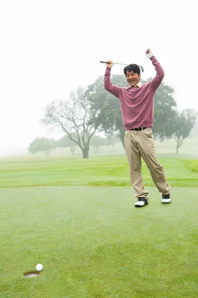 Excited golfer cheering on putting green — Stock Photo, Image