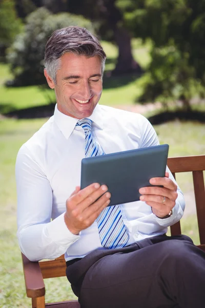 Empresario usando tableta en el parque —  Fotos de Stock