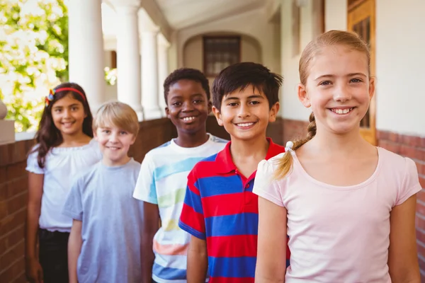 Smiling little school kids in school corridor — Stock Photo, Image