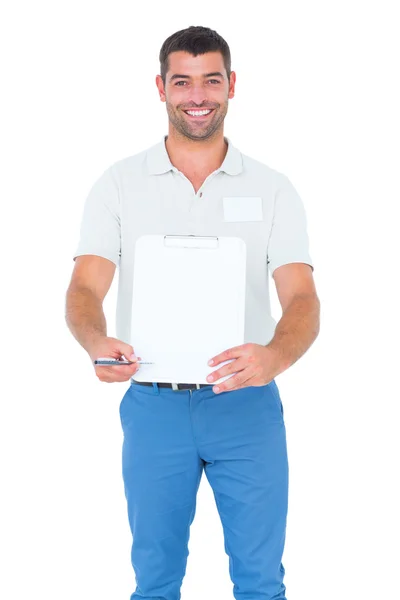 Delivery man giving clipboard for signature — Stock Photo, Image