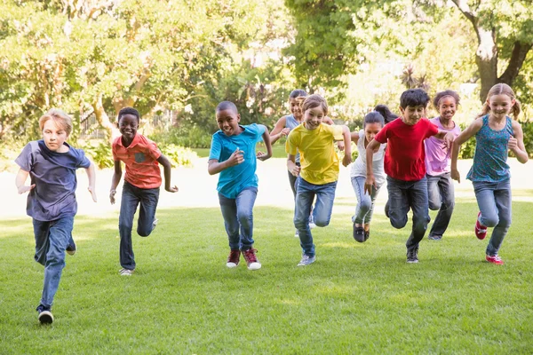 Happy friends running in the park — Stock Photo, Image