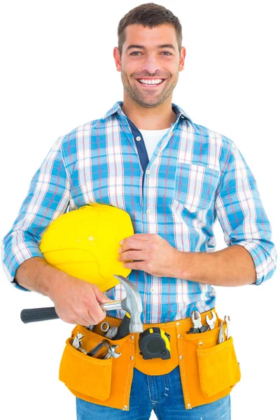 Handyman holding hardhat and hammer — Stock Photo, Image