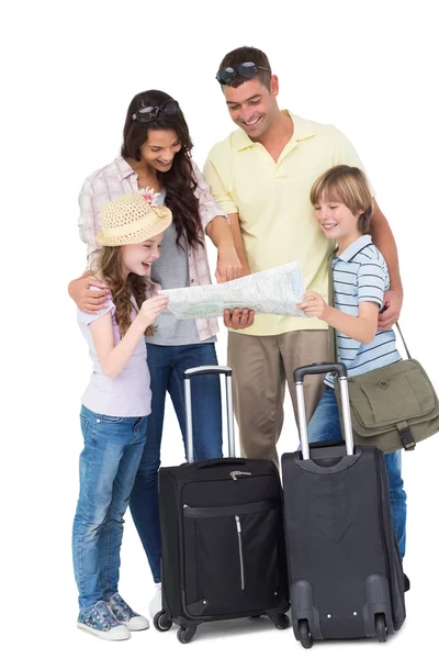 Family with luggage exploring map — Stock Photo, Image