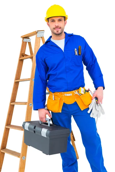 Smiling handyman holding tool box — Stock Photo, Image