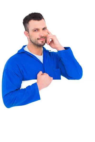 Handsome mechanic with blank placard — Stock Photo, Image