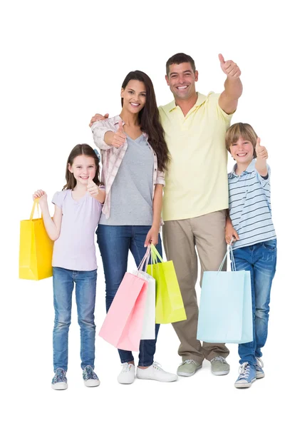 Famiglia con shopping bags gesticolando pollice in su — Foto Stock