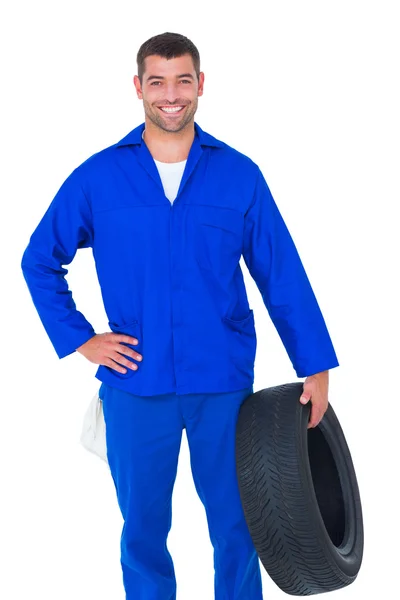 Smiling male mechanic holding tire — Stock Photo, Image