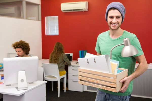 Casual businessman carrying his belongings in box — Stock Photo, Image