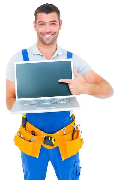 Glücklicher Reparateur zeigt auf Laptop — Stockfoto