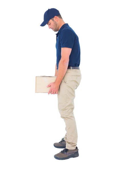 Delivery man carrying heavy package — Stock Photo, Image