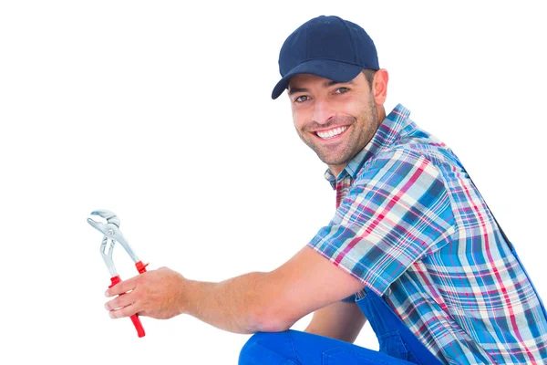 Happy handyman holding pliers — Stock Photo, Image