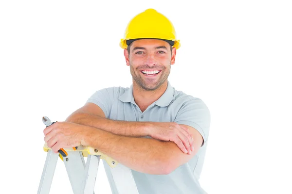 Happy repairman with pliers on ladder — Stock Photo, Image