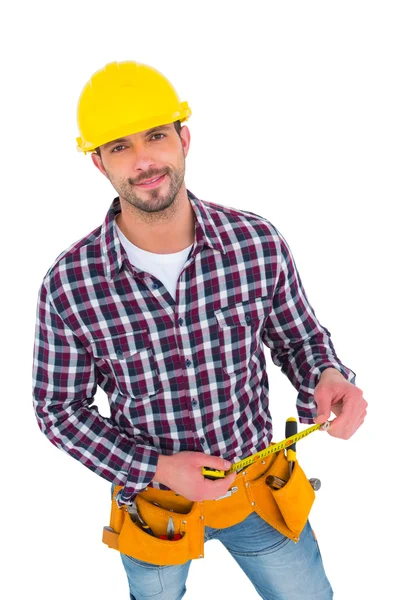 Smiling handyman holding tape measure — Stock Photo, Image