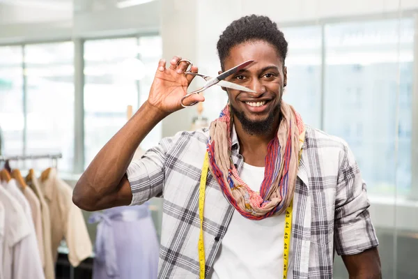 Happy male fashion designer holding scissors — Stock Photo, Image