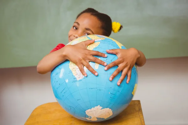 Cute little girl holding globe — Stock Photo, Image