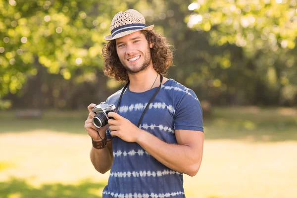 Handsome hipster using vintage camera — Stock Photo, Image