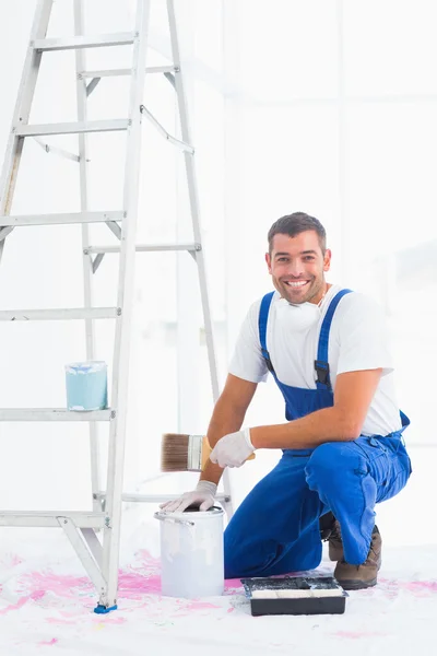 Handyman with paintbrush and can at home — Stock Photo, Image