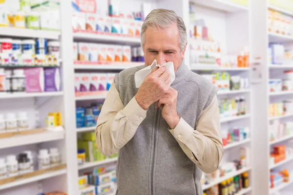 Sick customer sneezing on tissue — Stock Photo, Image
