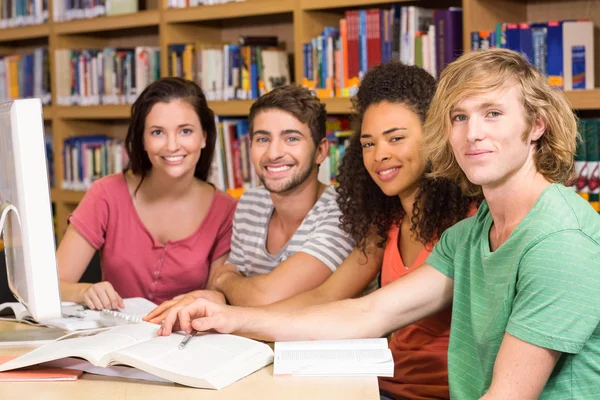 Estudiantes universitarios usando ordenador en la biblioteca — Foto de Stock