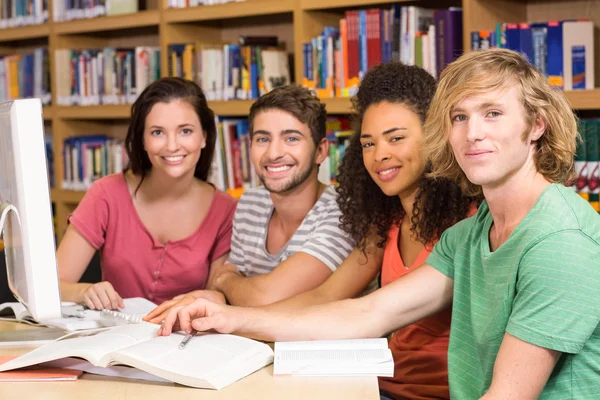 College students using computer in library Stock Picture