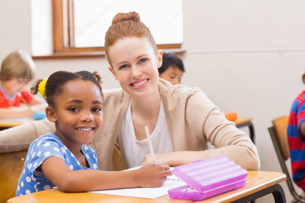 Pretty Teacher Helping Pupil In Classroom — Stock Photo