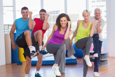 People performing aerobics exercise in gym class clipart