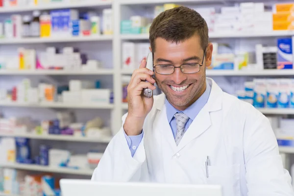 Happy pharmacist on the phone — Stock Photo, Image