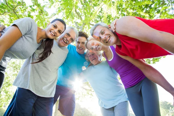 Happy athletic group looking down at the camera — Stock Photo, Image