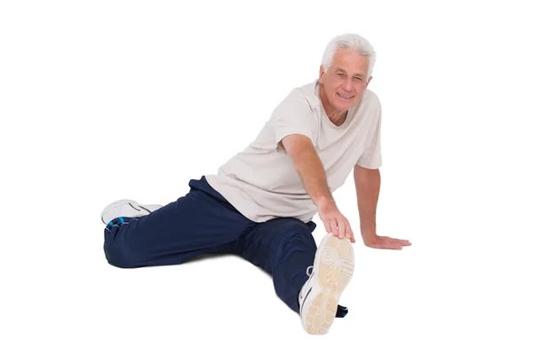 Senior man stretching his leg — Stock Photo, Image