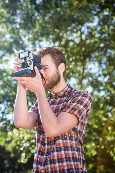 Handsome hipster using vintage camera — Stock Photo, Image