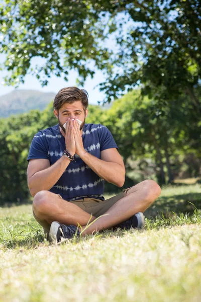 Handsome hipster blowing his nose — Stock Photo, Image