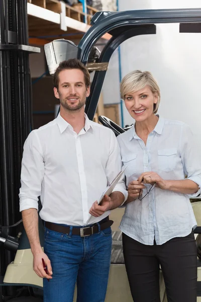 Smiling warehouse managers looking — Stock Photo, Image